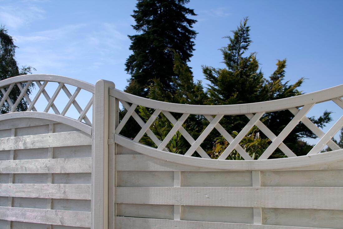 a white and tall fence