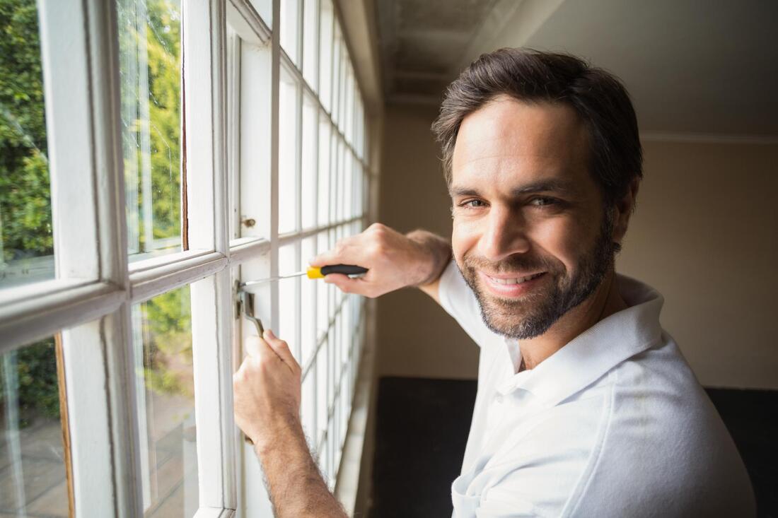 man repairing the window